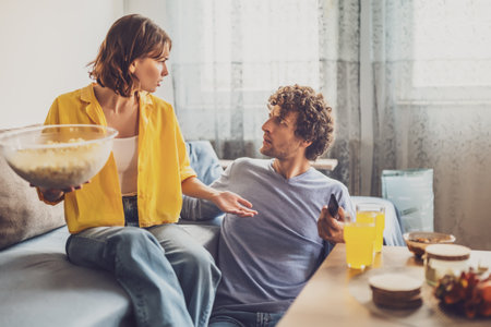 Man and woman are sitting at sofa and arguing. Relationship problems.の写真素材
