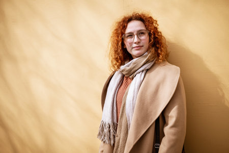 Natural portrait of smiling caucasian ginger woman with freckles and curly hair.の写真素材