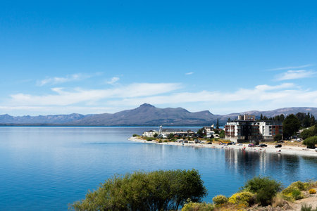 Beautiful scenic view of Lake Nahuel Huapi, San Carlos de Bariloche, houses on the coast on a clear spring dayの写真素材
