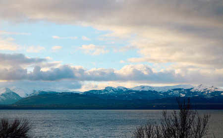 Evening sky with dramatic clouds over mountains, lake and trees. Dramatic sunset over the lakeの写真素材