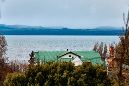 Buildings on the shore, against the backdrop of the lake and mountains, South Americaの写真素材