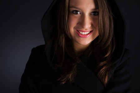 woman in coat on dark backgroundの写真素材