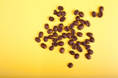 coffee beans on yellow backgroundの写真素材