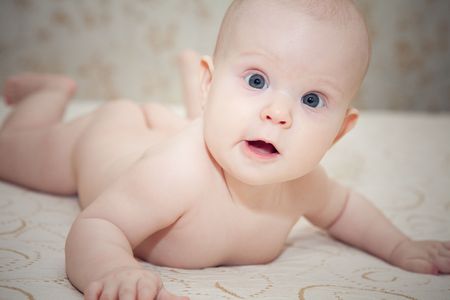 Little sweet baby girl on bed