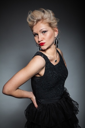 beautiful women in black dress posing on dark backgroundの写真素材