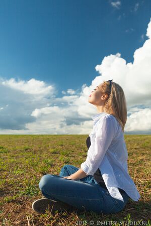 beautiful asian woman looks at cloudsの写真素材