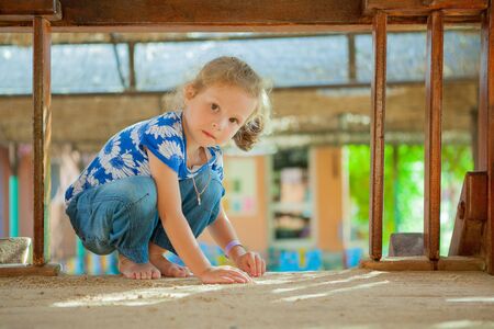 The beautiful girl playing to a sandboxの写真素材
