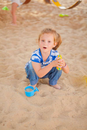 The beautiful girl playing to a sandboxの写真素材