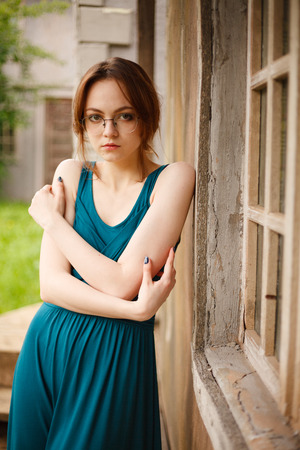 Portrait of young brunette woman by ancient wallの写真素材