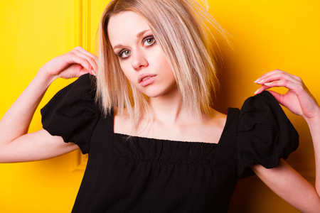Portrait of pretty lean girl on yellow backgroundの写真素材