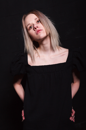 Beautiful young women posing on black backgroundの写真素材