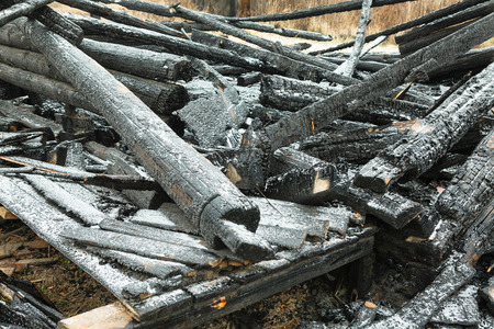 burnt-out wooden house in old villageの写真素材