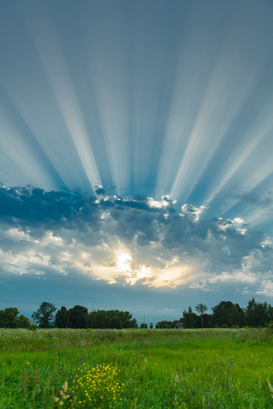 cloudy sky and bright rays of sundownの写真素材