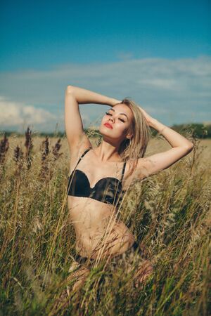Beautiful asian woman posing on green fieldの写真素材