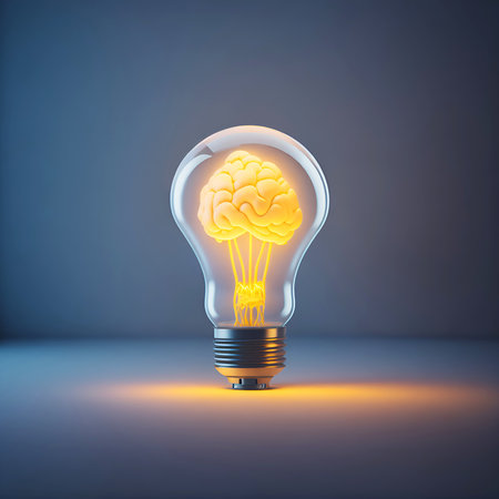 Human brain glowing inside of light bulb on dark backgroundの素材