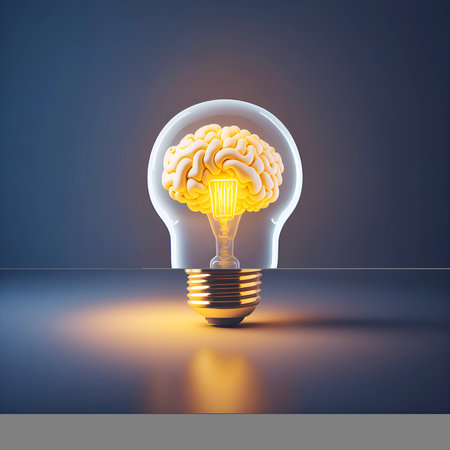Human brain glowing inside of light bulb on dark backgroundの素材