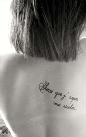 Girl with a tattoo on her backの写真素材