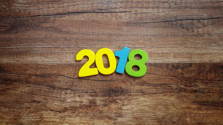 Wooden numbers forming the number 2018, For the new year 2018 on a rustic wooden background.