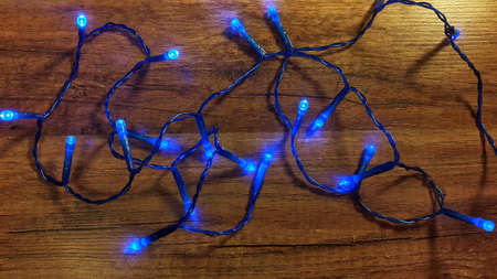 Christmas lights on wooden backgroundの写真素材