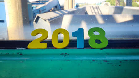 Wooden numbers forming the number 2018, For the new year 2018 on a abstract backgroundの写真素材