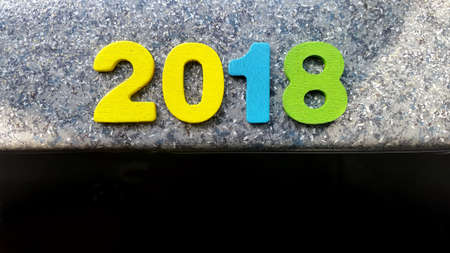 Wooden numbers forming the number 2018, For the new year 2018 on a abstract backgroundの写真素材