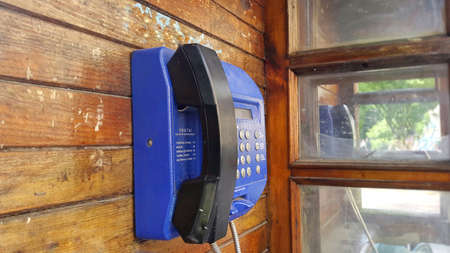 wooden call box with blue telephoneの写真素材