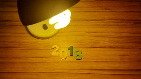 Wooden olored numbers forming the number 2018, For the new year 2018 on a wooden background.の写真素材