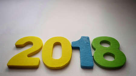 Wooden olored numbers forming the number 2018, For the new year 2018 on a wooden background.の写真素材
