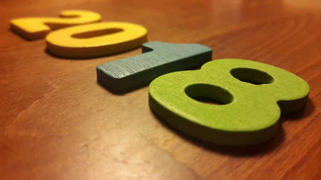 Wooden olored numbers forming the number 2018, For the new year 2018 on a wooden backgroundの写真素材