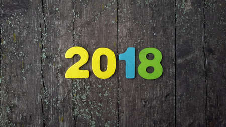 Happy New Year 2018. Numbers forming the number 2018, For the new year 2018 on rustic wooden tableの写真素材