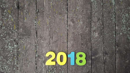 Happy New Year 2018. Numbers forming the number 2018, For the new year 2018 on rustic wooden tableの写真素材