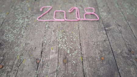 Happy New Year 2018. Numbers forming the number 2018, For the new year 2018 on rustic wooden table.の写真素材