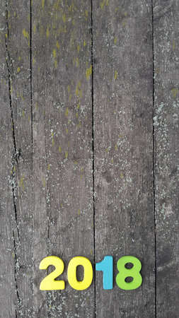 Happy New Year 2018. Numbers forming the number 2018, For the new year 2018 on rustic wooden table.の写真素材
