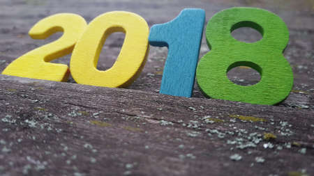 Happy New Year 2018. Numbers forming the number 2018, For the new year 2018 on rustic wooden table.の写真素材