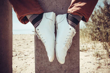 Legs modern hipster sitting on the poleの写真素材