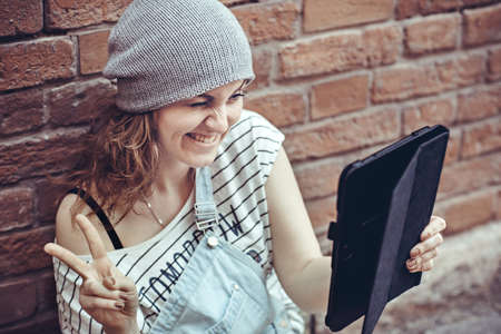 Girl sitting on the floor with a laptop with a look of successの写真素材
