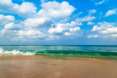 Beautiful beach and blue sky. Wave of the sea on the sand beach