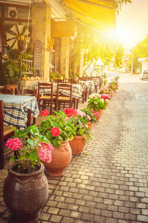 Beautiful greek cafe terrace in Heraklion, Crete with typical pots and flowersの写真素材