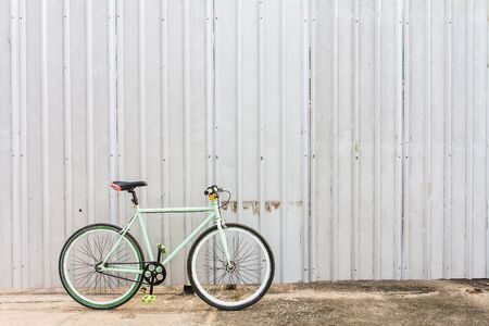 Bicycles parked on the side of sheet metal wall.の写真素材