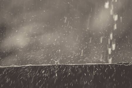 Rainwater falling on the wall to rebound, a beautiful background. Vintage picture style.の写真素材