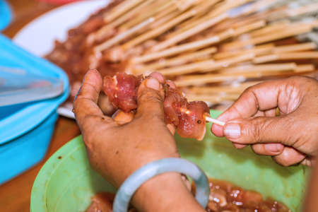 wood stick in raw pork for sell in the market. Thai traditional food.の写真素材