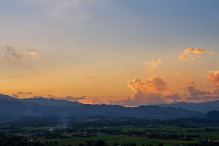 The background image of the sun falling behind the mountains.