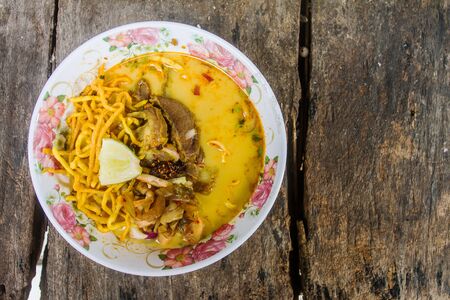 Traditional Thai food - Khao soy noodle, curry soup with yellow noodle and meat.の写真素材