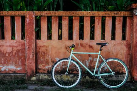 bicycle and red cement wall as background.の写真素材