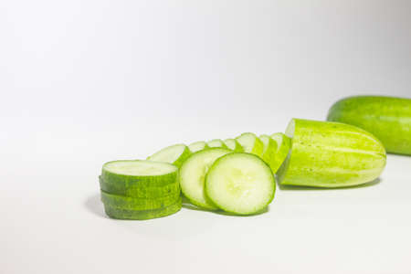 Cucumber slice is arranged on the white isolated background.の写真素材