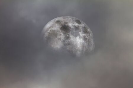 The moon in the clouds as background.