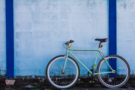 Cycling and Blue color wall which as the background.の写真素材