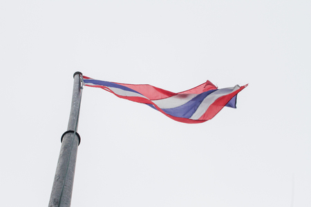 Thailand flag fluttering in the breeze as the background.
