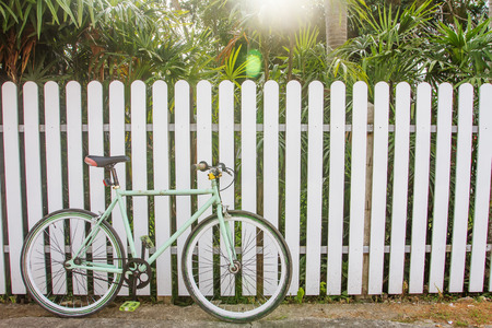 Bicycle and wooden fence which is the background.の写真素材