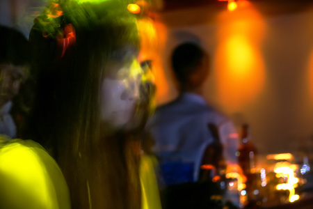abstract image of a beautiful DJ girl are dancing music. focus lens blur.の写真素材